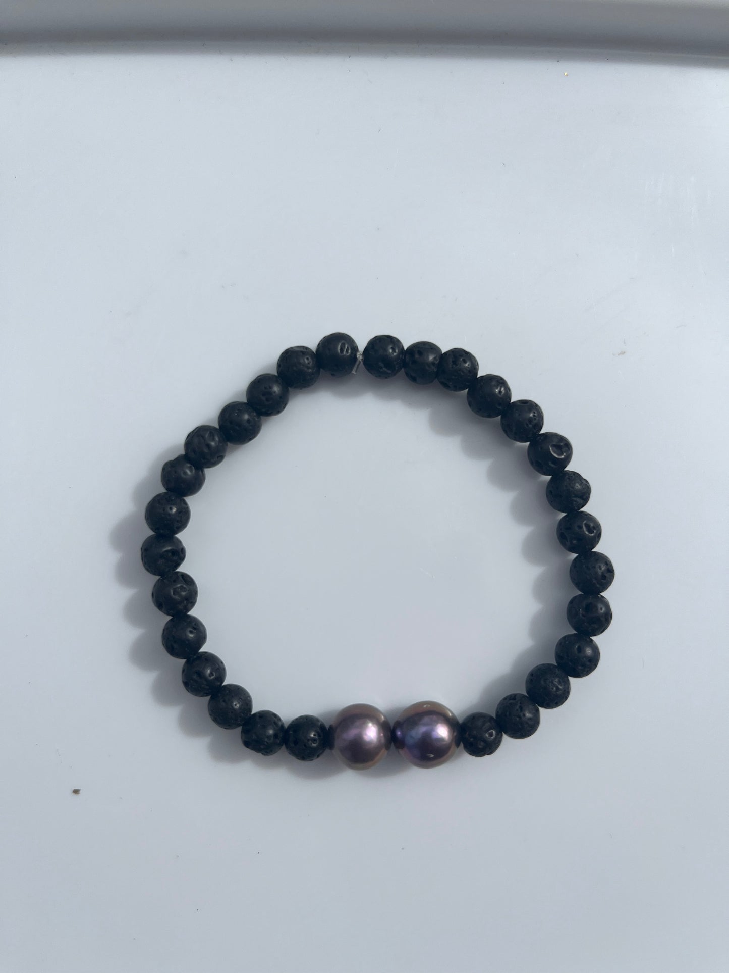 Two purple Edison pearls with small faux lava rock